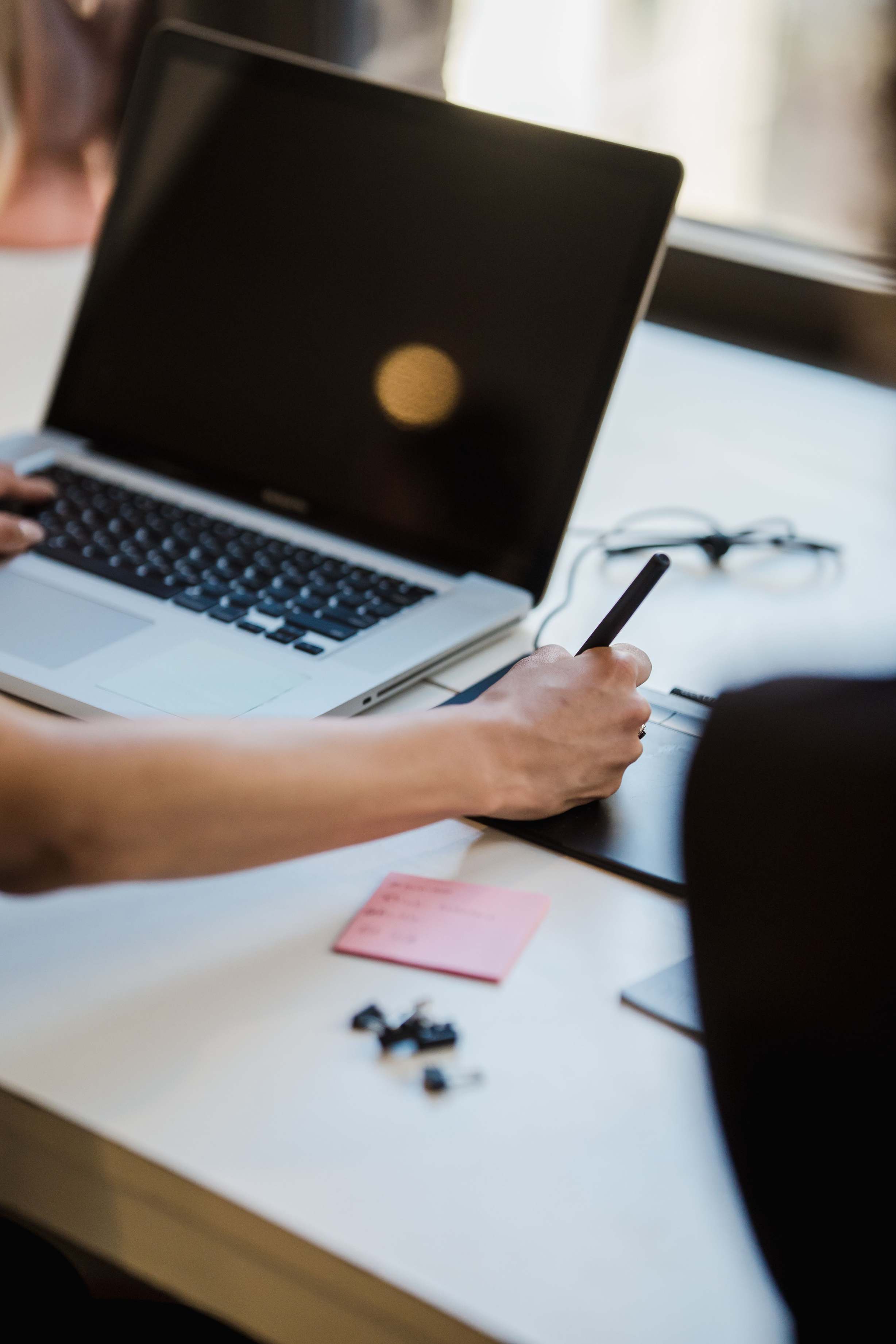 Developer workspace with laptop on a desk in a modern office